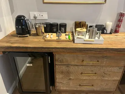 a kitchen with a wooden counter top with a microwave at Zeven Eike Homestead in Stellenbosch