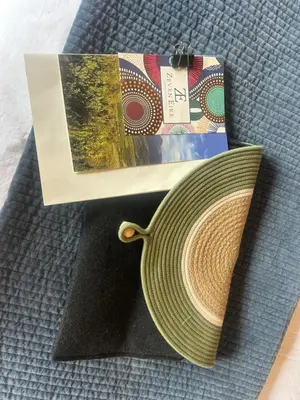 a shopping bag and a hat on a table at Zeven Eike Homestead in Stellenbosch
