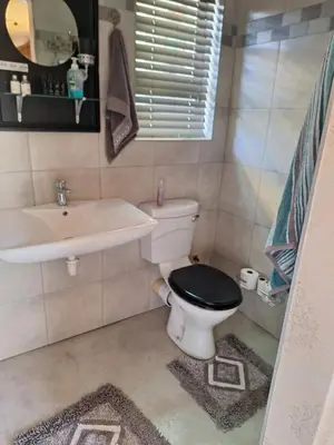 a bathroom with a toilet and a sink at Kraaifontein Family Home in Cape Town