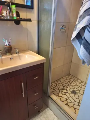 a bathroom with a sink and a shower at Kraaifontein Family Home in Cape Town