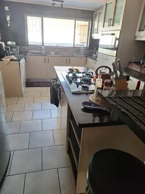 a kitchen with a stove and a counter top at Kraaifontein Family Home in Cape Town