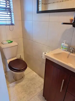 a bathroom with a toilet and a sink at Kraaifontein Family Home in Cape Town