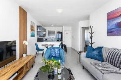 a living room with a couch and a table at The Bay A602 in Cape Town