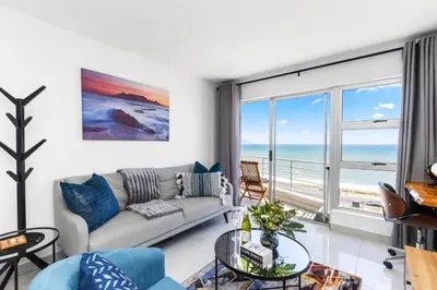 a living room with a couch and a view of the ocean at The Bay A602 in Cape Town