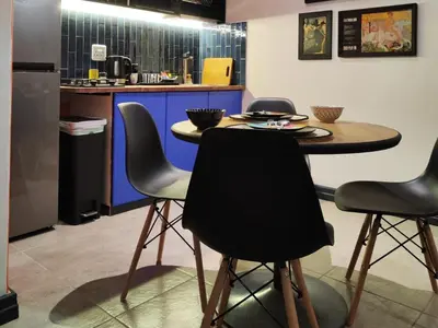 a kitchen with a table and four chairs at Haus Michau in Strand
