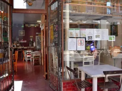 a restaurant with a table and chairs in a room at Obs Centre Twin Peaks in Cape Town