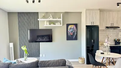 a living room with a couch and a table at Obs Centre Luxe Loft in Cape Town