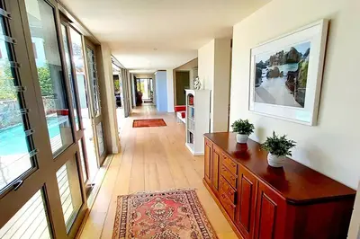 a hallway of a home with a dresser and a room at Knight's House 6 sleeper in Hermanus
