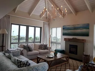 a living room with couches and a chandelier at Knight's House 6 sleeper in Hermanus
