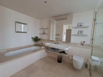 a bathroom with a tub and a sink and a toilet at Knight's House 6 sleeper in Hermanus