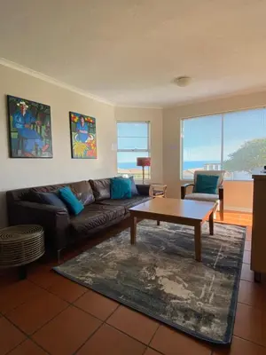 a living room with a couch and a coffee table at The Hermanus holiday self catering beach club in Hermanus