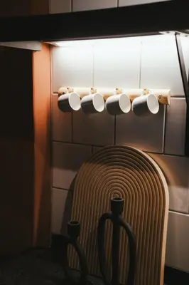 a rack of coffee cups hanging on a wall at No 3 at The Barracks in Stellenbosch