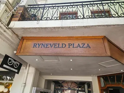 a shop with a sign on the front of a building at PinotageLuxuryCollection 16 Ryneveld Plaza in Stellenbosch
