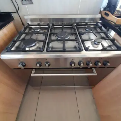 a stove top oven sitting in a kitchen at Jacuzzi with 270 views right on beach in Cape Town