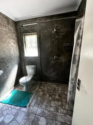 a bathroom with a toilet and a shower with a glass door at Jacob's Rest in Cape Town