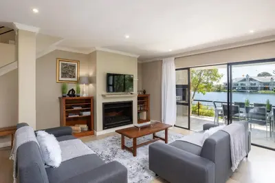 a living room with two couches and a fireplace at Luxury Lodge 4F Pearl Valley Golf Estate in Simondium