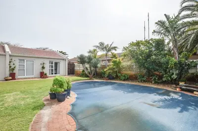a swimming pool in the yard of a house at Pet friendly & Close to Beach at 2 Saasveld in Bloubergstrand