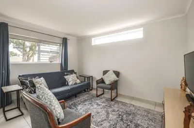 a living room with a couch and two chairs at Pet friendly & Close to Beach at 2 Saasveld in Bloubergstrand