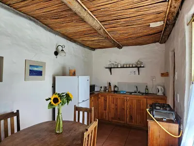 a kitchen with a table and a refrigerator at Whipstock Guest Farm in McGregor