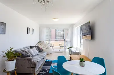 a living room with a couch and a table at Ocean View B104 by CTHA in Bloubergstrand