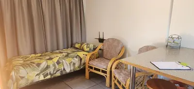 a room with a bed and a table and chairs at HartebeesDen in Worcester