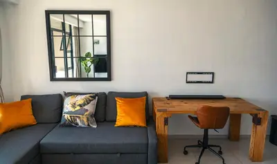 a living room with a couch and a wooden table at Beachside Escape in Cape Town