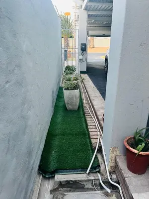 a hallway with a green floor in a house at Self catering one bedroom cottage in Cape Town