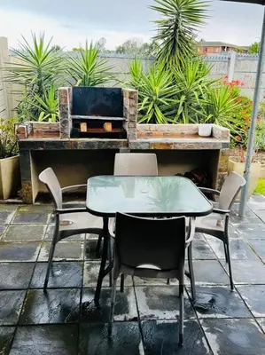a table and chairs sitting in front of a piano at Boho Bliss in Cape Town