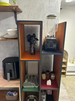 a book shelf with a blender and a blender at La Casetta, Garden Retreat in Cape Town