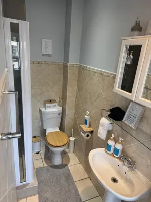 a bathroom with a toilet and a sink at Windpomp Self Catering in Paarl