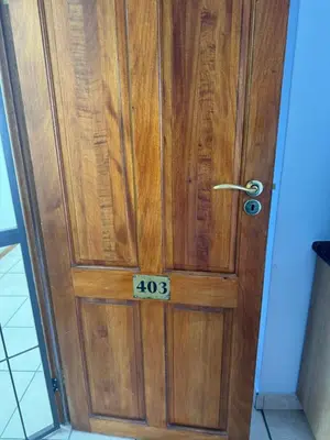 a wooden door with the number on it at Windpomp Self Catering in Paarl
