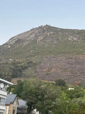 a mountain in the distance with houses and trees at Windpomp Self Catering in Paarl
