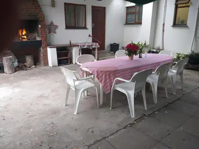 a table and chairs with a table and a fireplace at Mogit-ewig-duur in Hermanus