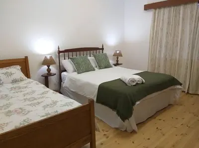 a bedroom with two beds with green and white sheets at Mogit-ewig-duur in Hermanus