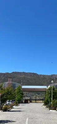 a parking lot with a bridge in the background at V's Condo in Gordonʼs Bay