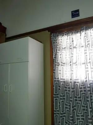 a window in a room with a curtain and a refrigerator at Room Parow, Cape Town in Cape Town