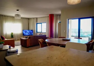 a living room with a table and a couch at Knightsbridge Luxury Escape in Cape Town