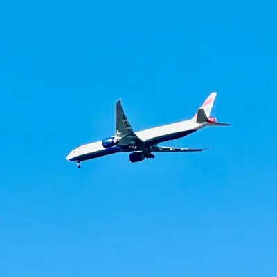 a plane flying in the blue sky at Bonita Vista Plattekloof in Cape Town