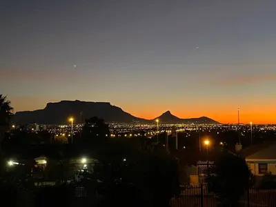 a view of a city at night with mountains at Bonita Vista Plattekloof in Cape Town