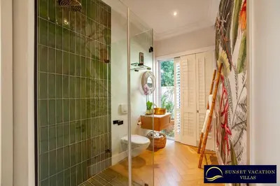 a bathroom with a shower and a toilet in it at Sunsets Jasmine Villa in Cape Town