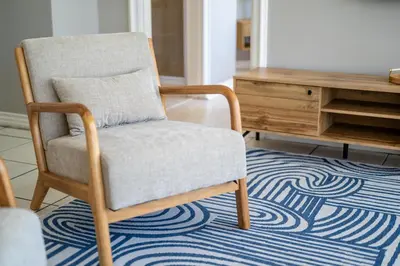 a chair sitting on a rug in a living room at 4 Serene Palms in Cape Town
