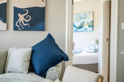 a living room with a blue pillow on a couch at 4 Serene Palms in Cape Town