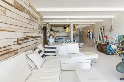 a living room with white furniture and a wooden wall at Dolphin Hill Apartment, Cape Town, Dolphin Beach in Cape Town