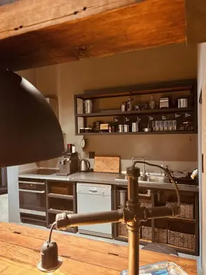 a kitchen with a table with a lamp in it at Tether and Tease, The Citadel in Cape Town
