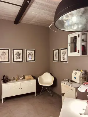 a kitchen with a table and a chair in a room at Tether and Tease, The Citadel in Cape Town
