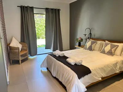 a bedroom with a large bed with towels on it at 2stay Apartment Calla - Cape Town Bloubergstrand in Cape Town