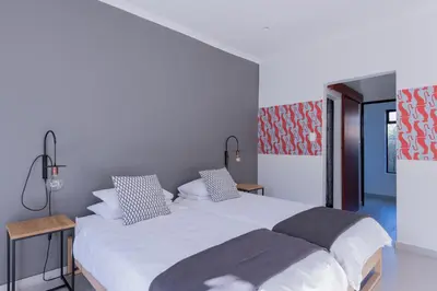 a bedroom with a large white bed with two pillows at 2stay Apartment Calla - Cape Town Bloubergstrand in Cape Town