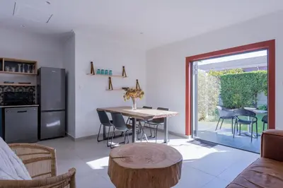 a kitchen and dining room with a table and chairs at 2stay Apartment Calla - Cape Town Bloubergstrand in Cape Town