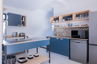 a kitchen with blue cabinets and a counter top at 2stay Apartment Calla - Cape Town Bloubergstrand in Cape Town