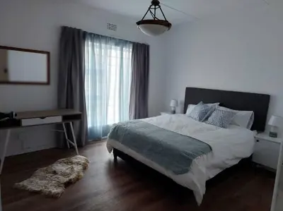 a bedroom with a large bed and a window at Azzure Apartments 3 sleeper Strand in Strand